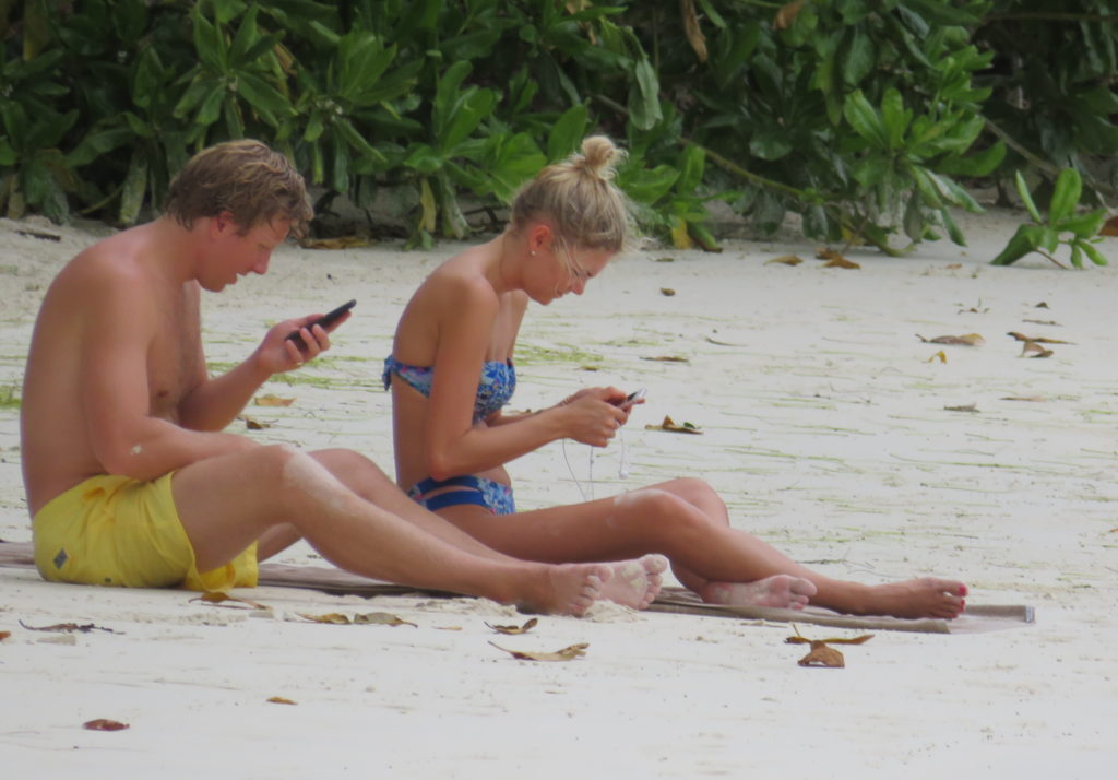 Tiurists Sunbathing at Port Launay Beach Mahe